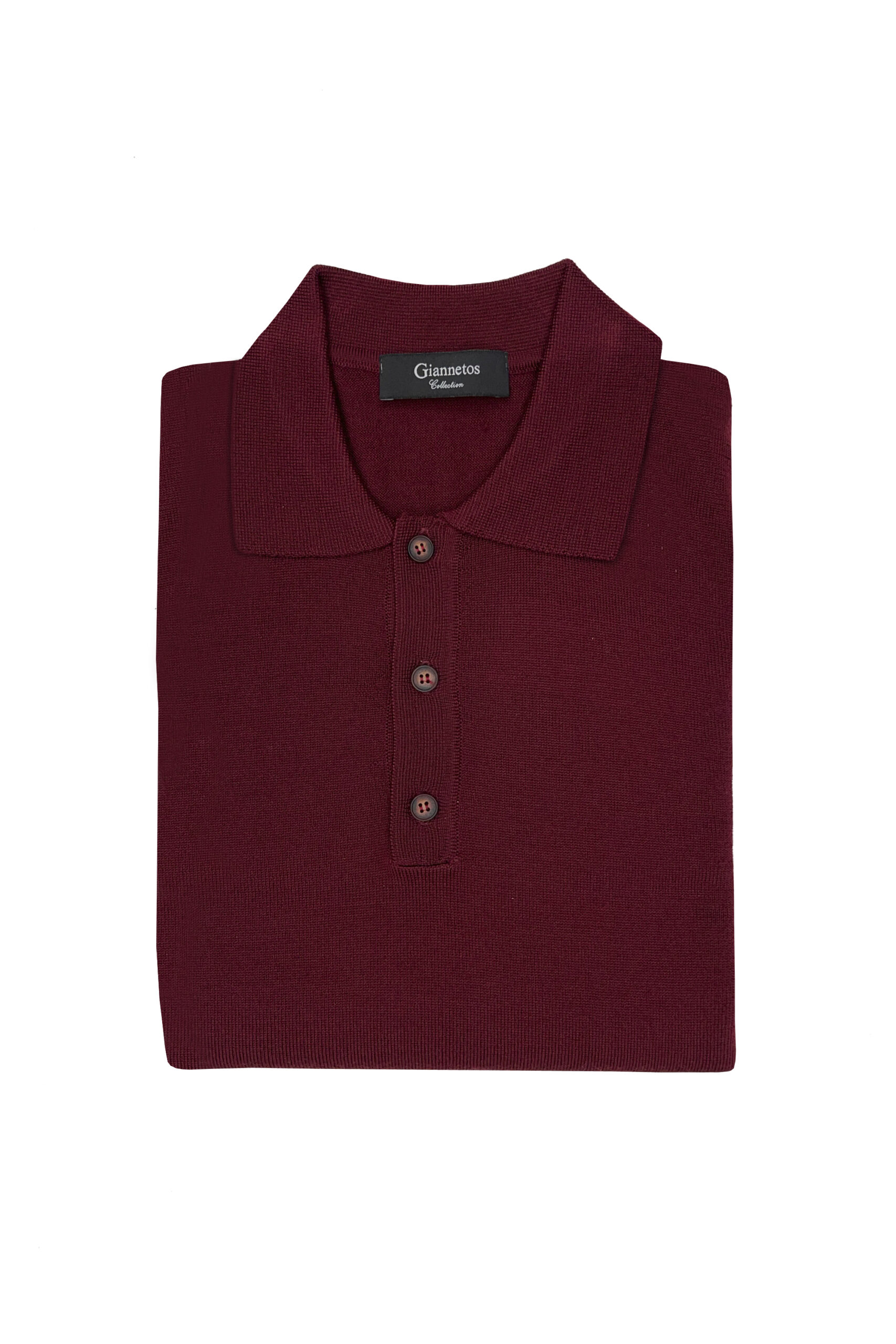 Folded maroon polo shirt with a brand label on a white background